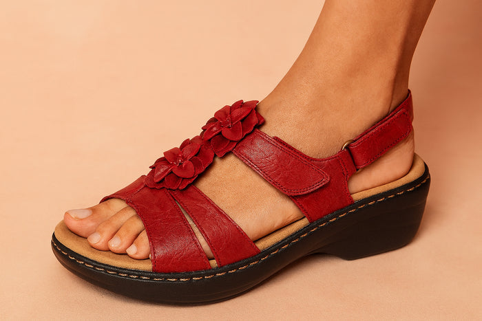 Close-up of crisscross strap detail on floral wedge sandals